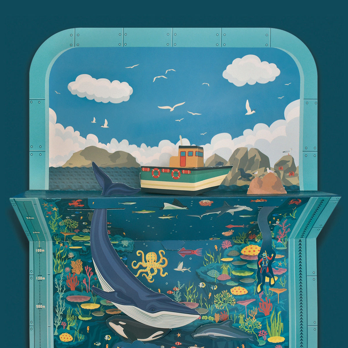 3D papercraft seascape diorama featuring a boat above water and a large blue whale swimming below.