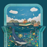 3D papercraft seascape diorama featuring a boat above water and a large blue whale swimming below.