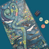 Ocean-themed board game mat featuring sea creatures, a winding game path, die, and player tokens.