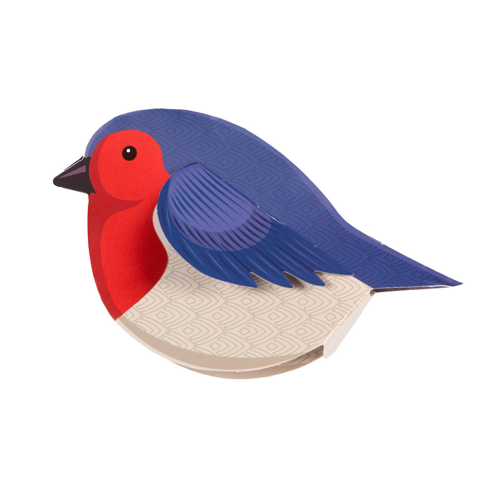 Illustrated bird with a vibrant red face and breast, blue head and wings, and a beige patterned body. The style is playful and geometric.