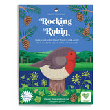 Illustrated packaging featuring a vibrant red-breasted robin perched on a tree stump against a scenic landscape. The text reads "Rocking Robin" with eco-friendly logos. Pine branches and cones frame the top, with green hills in the background. The tone is cheerful and nature-focused.