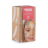 Close-up of Namaki Flower Fairy Face Painting Kit in sustainable cardboard packaging with a smiling child displaying floral-themed face paint.