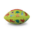 A light green football featuring colorful cartoon dinosaurs, including red, blue, and purple figures. Red laces on top add a playful touch.