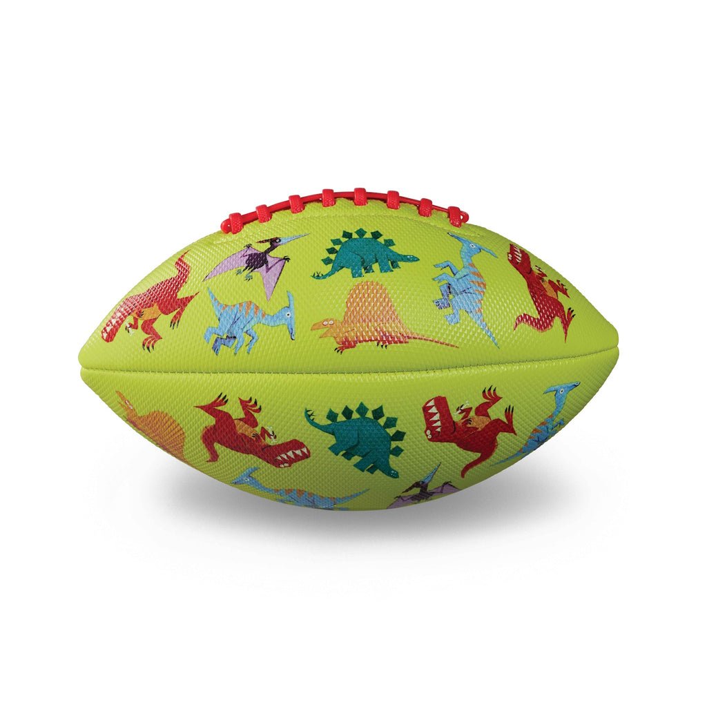 A light green football featuring colorful cartoon dinosaurs, including red, blue, and purple figures. Red laces on top add a playful touch.