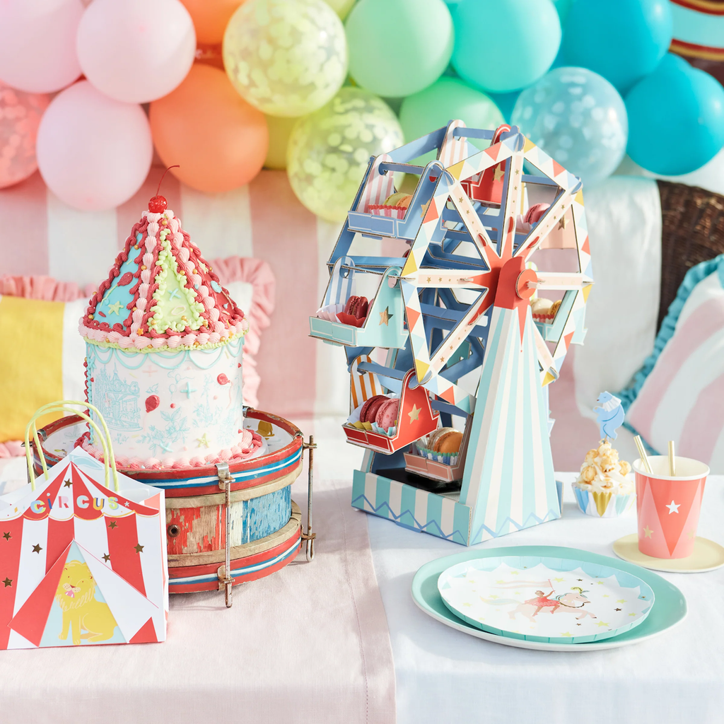 A fun and colorful table decoration featuring a Ferris wheel design with spaces to display cupcakes or treats, perfect for parties and celebrations.