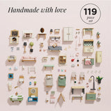 A knolled layout of a 119-piece wooden dollhouse furniture set in pastel colors against a pink background.