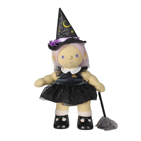 Plush doll in a black witch dress and pointed hat, holding a toy broom on a white background.