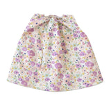 Olli Ella Dinkum Doll Suki Dress with a purple and pink floral pattern and a small front pocket.