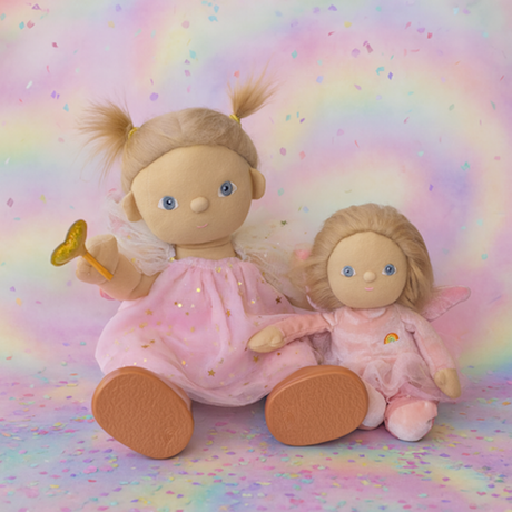 Two Olli Ella Dinkum dolls dressed as pink fairies with wings, sitting on a colorful rainbow background.
