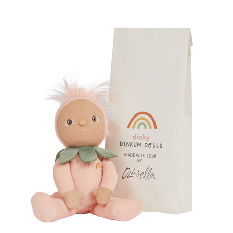 Olli Ella Dinky Dinkums Peggy Peach doll sitting next to its paper bag packaging.