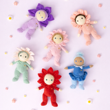 Six colorful Olli Ella Dinky Dinkum flower and fairy plush dolls arranged on a purple background.
