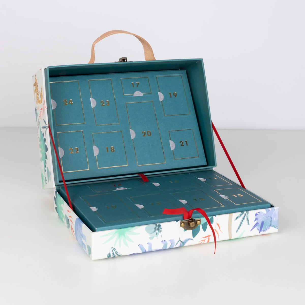 Open dinosaur-themed advent calendar suitcase revealing numbered teal countdown compartments.