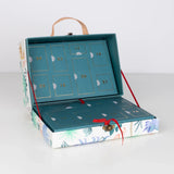 Open dinosaur-themed advent calendar suitcase revealing numbered teal countdown compartments.