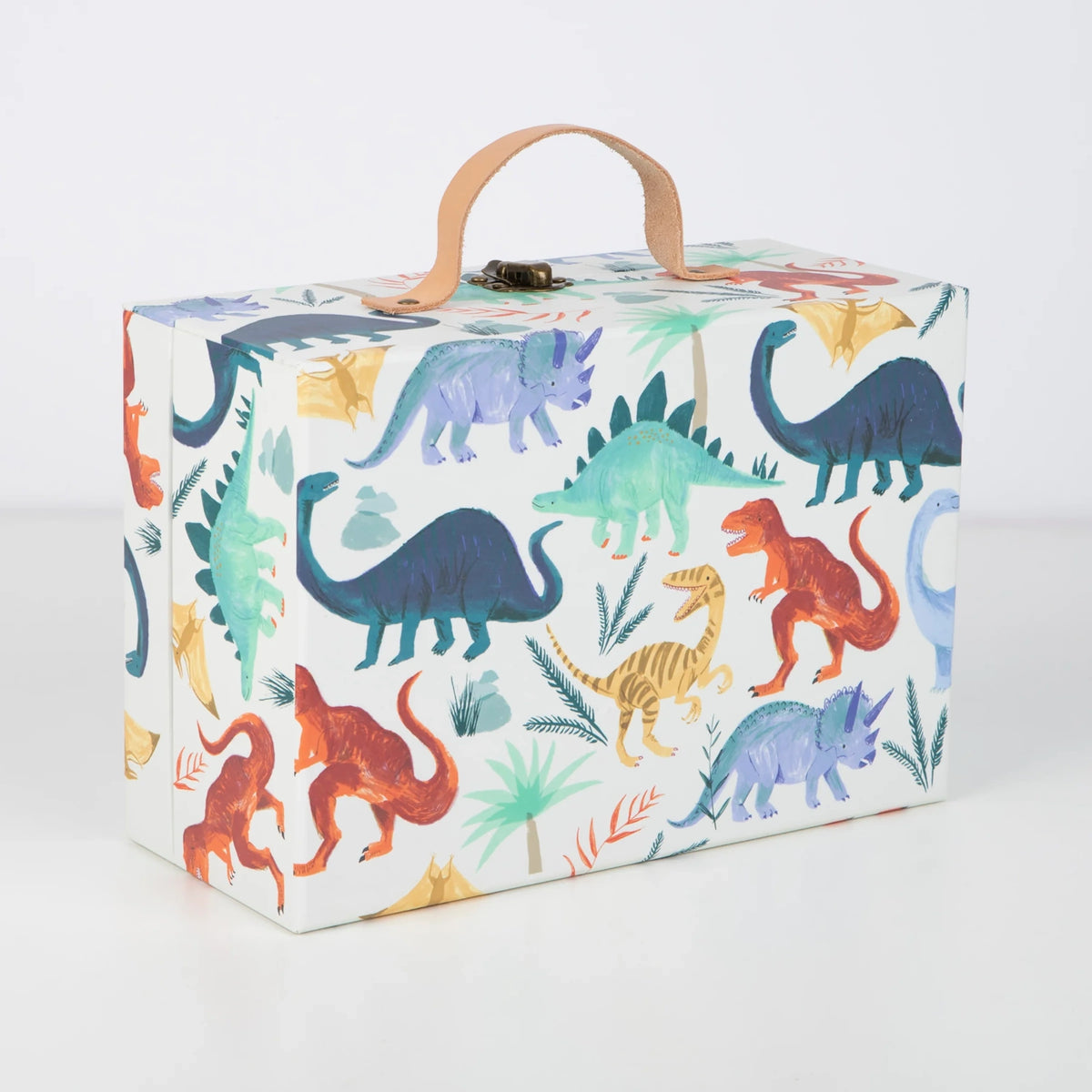 Closed dinosaur advent calendar suitcase with leather handle, metal clasp, and colorful dinosaur pattern.