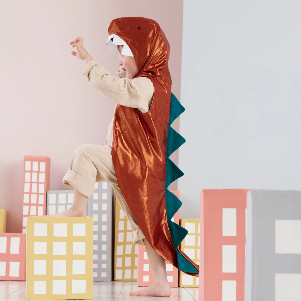 A fun costume set featuring a green dinosaur cape with felt spikes and a matching headpiece, perfect for imaginative play and parties.