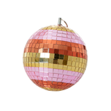 A striped disco ball with pink, orange, and gold tiles against a solid white background.