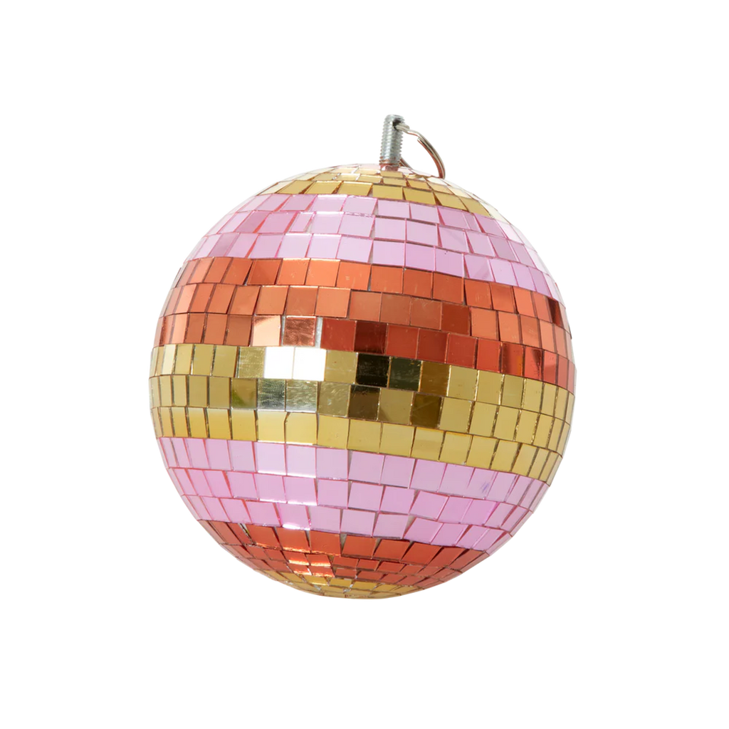 Colorful disco ball with pink, red, and gold mosaic tiles on a white background, reflecting light playfully, evoking a festive, lively mood.