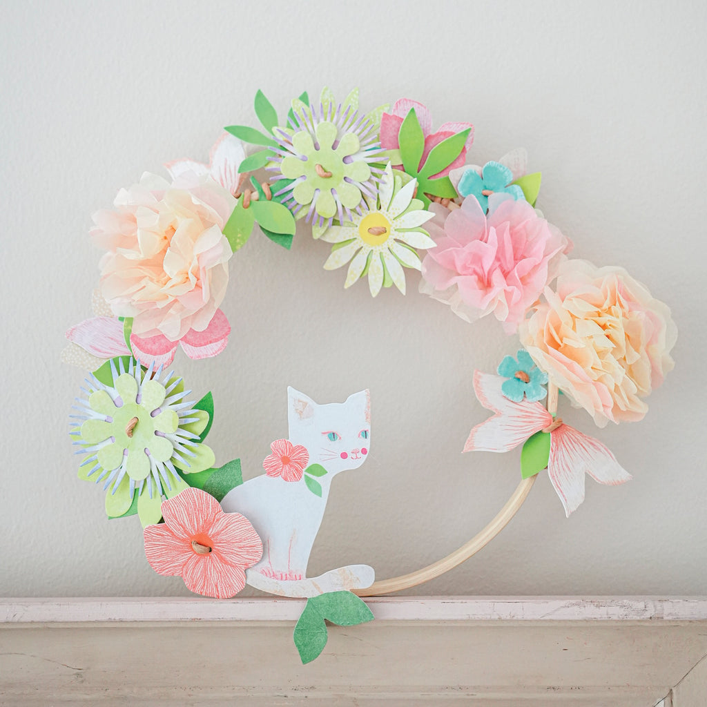 A DIY craft kit with delicate paper flowers and ribbon for children to create a beautiful, wearable floral crown.
