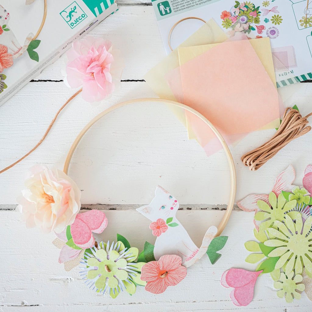 A DIY craft kit with delicate paper flowers and ribbon for children to create a beautiful, wearable floral crown.