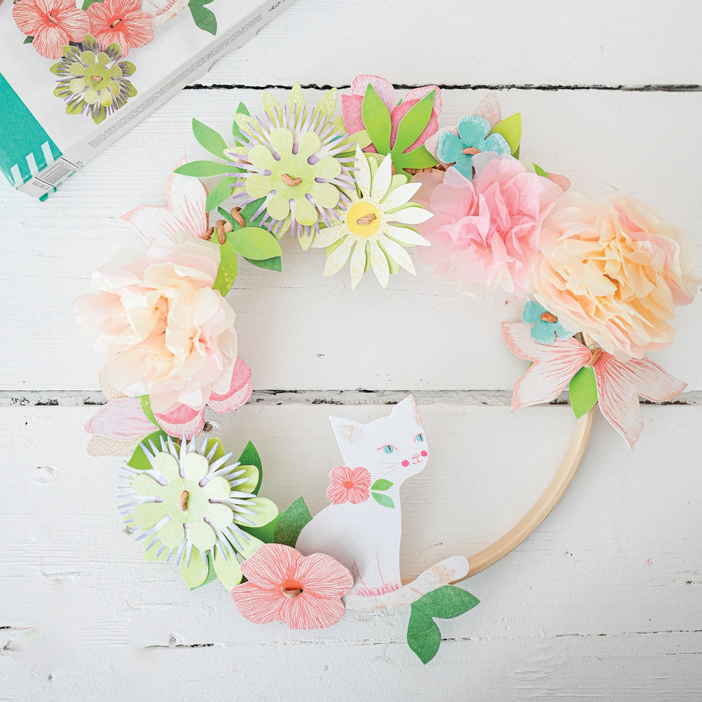 A DIY craft kit with delicate paper flowers and ribbon for children to create a beautiful, wearable floral crown.