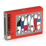A brightly colored game box labeled "Sardines" in bold text features stylized fish with clothing and accessories against a red background. Suitable for ages 5 to 99.