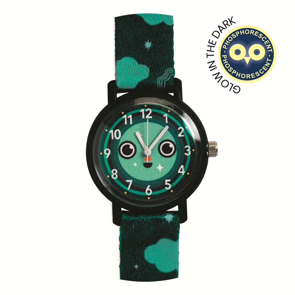 Playful wristwatch with a green face displaying a cute smiley, wide eyes, white hands, and a strap with clouds and stars, conveying a fun tone.