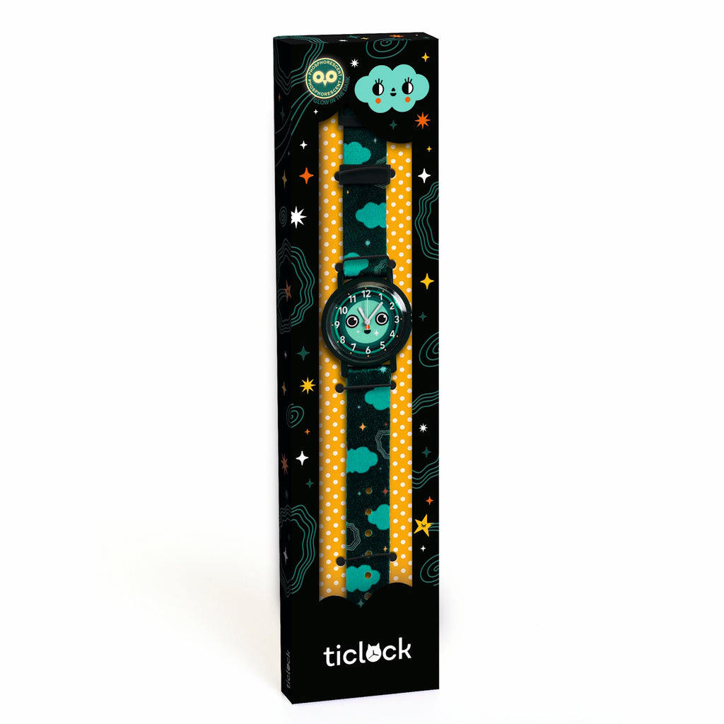 Colorful children's watch in themed packaging with clouds and stars. The watch face has a playful owl design. The strap is blue with cloud motifs.