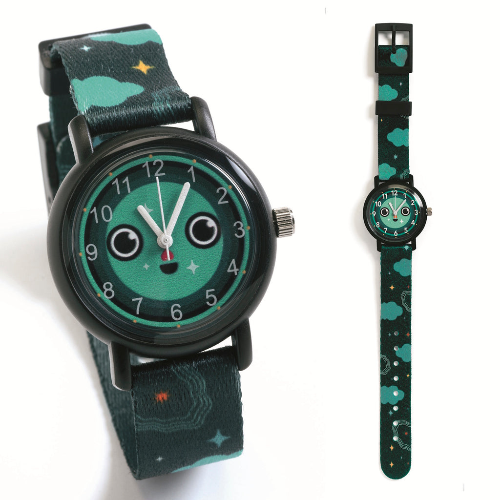 Playful wristwatch with a green face displaying a cute smiley, wide eyes, white hands, and a strap with clouds and stars, conveying a fun tone.