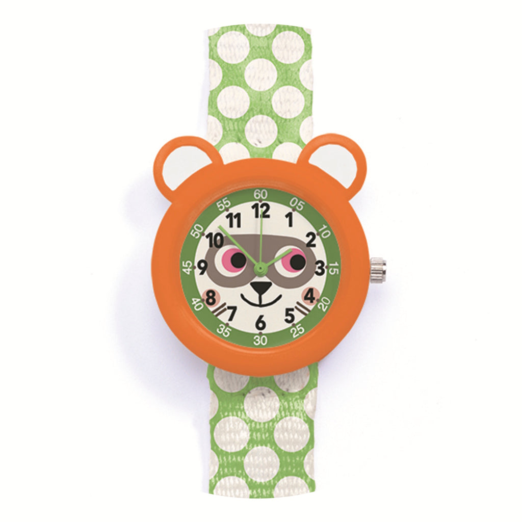 Child's watch with an orange bear face design, featuring playful pink eyes. The strap is green with white polka dots, adding a fun, lively touch.