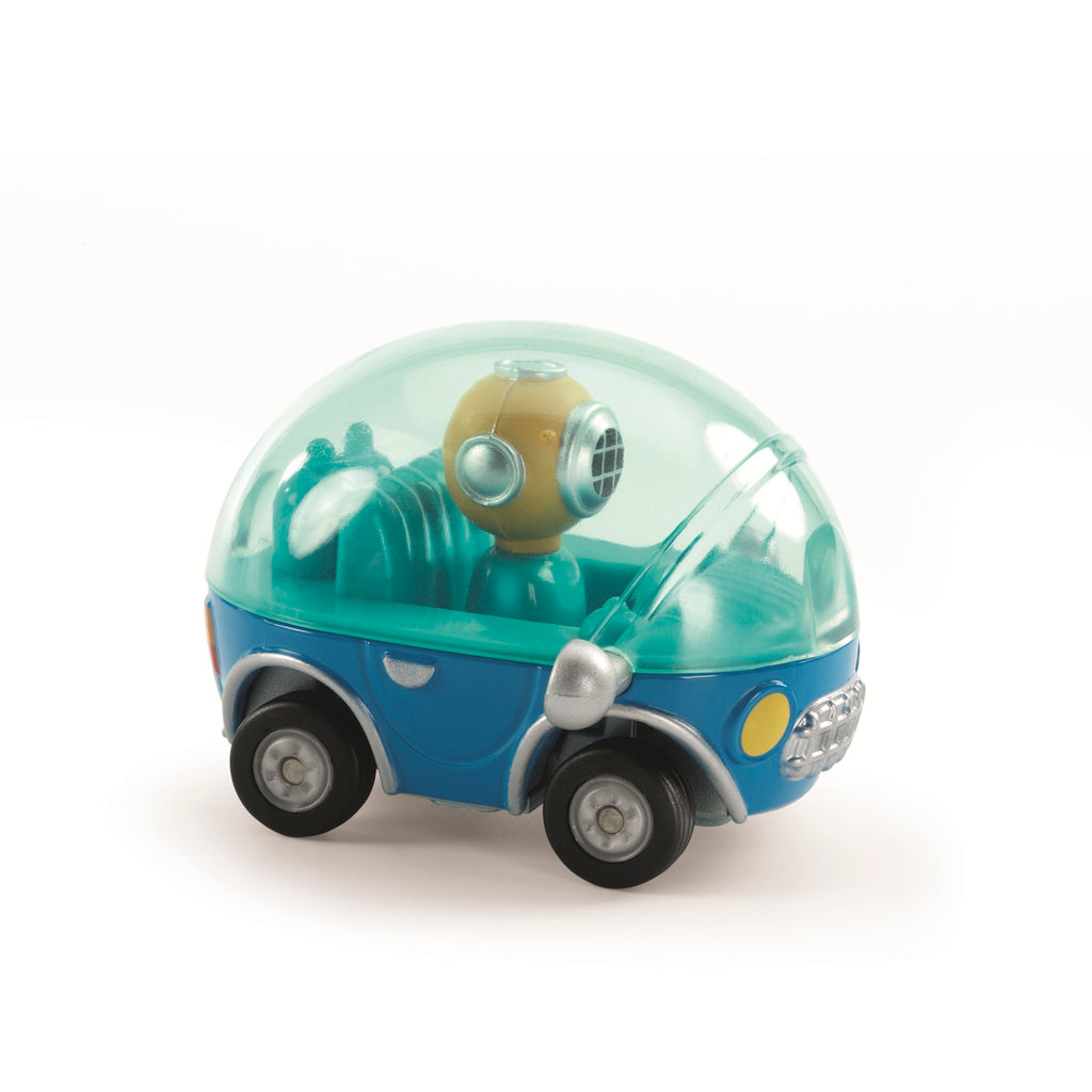 A small, blue toy car with a transparent dome reveals a seated figure wearing a diving helmet. The design is playful and whimsical.