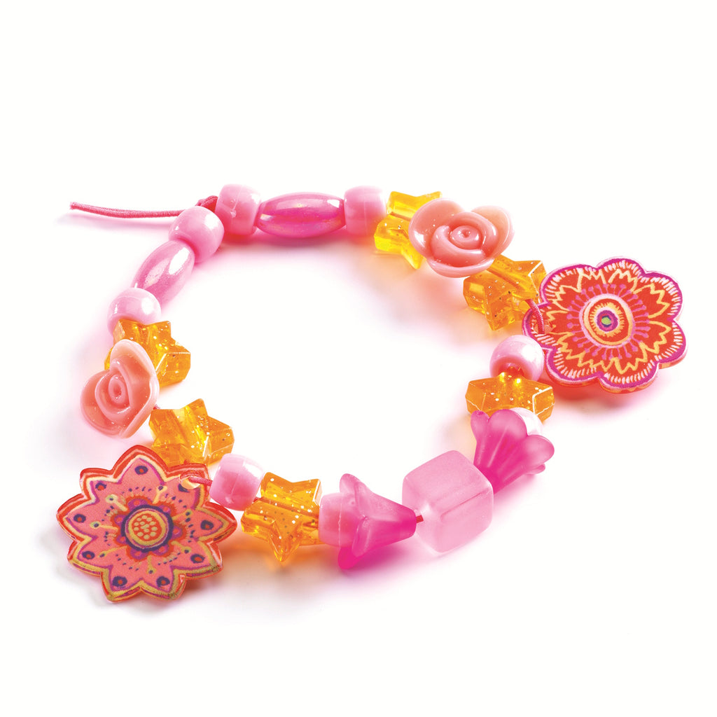 Colorful handmade beaded bracelet featuring pink flowers, yellow stars, and vibrant glass beads on a white background.