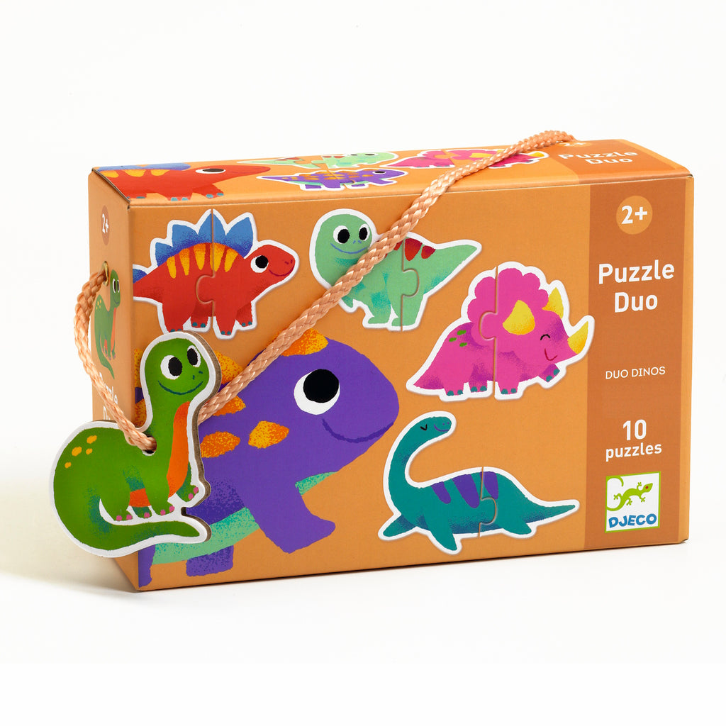 Orange puzzle box with colorful cartoon dinosaurs, featuring a handle. Text reads “Puzzle Duo,” “10 puzzles,” and “2+” in playful fonts.
