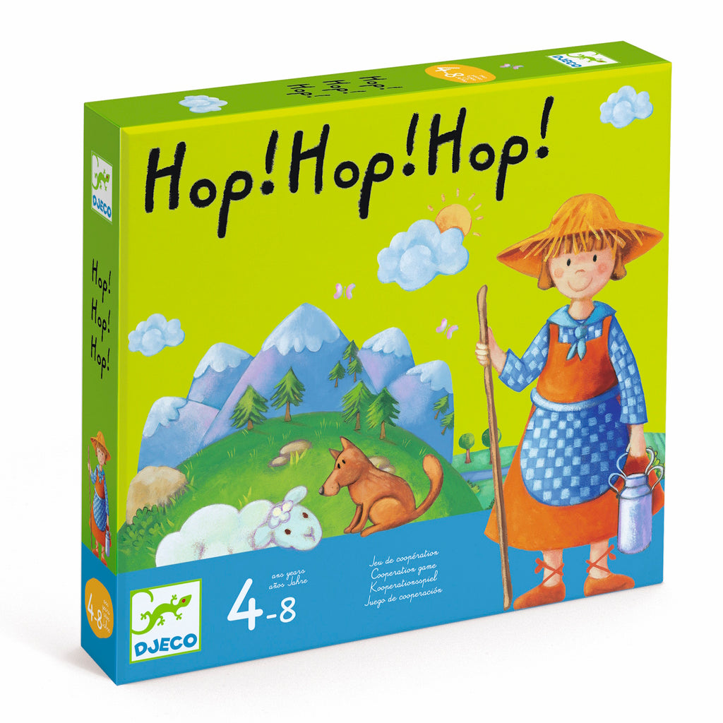 Bright game box featuring "Hop! Hop! Hop!" text at the top. Shows a smiling shepherd in a straw hat, sheep, and a dog on a green landscape with mountains. Suitable for ages 4-8.