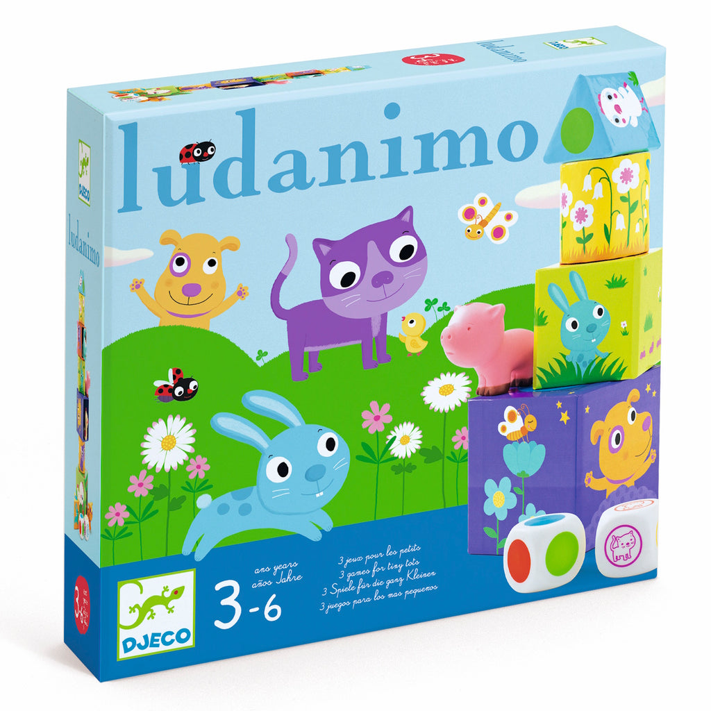 Colorful children's game box labeled "Ludanimo" features cartoon animals on a grassy field with flowers. Includes stacking blocks and dice for ages 3-6.
