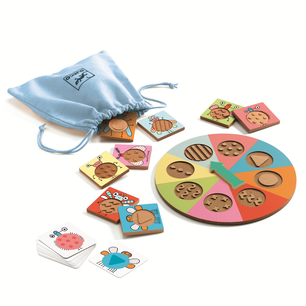 A colorful children's game with a spinner wheel divided into sections, each with a unique pattern. Nearby are illustrated cards featuring cute bugs and a light blue drawstring bag. The playful design conveys a fun and engaging activity.