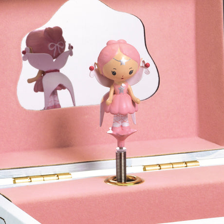 When the crank is turned, the box opens to reveal Elfe, a delicately sculpted figurine, who dances and turns to the music against a backdrop of golden stars.