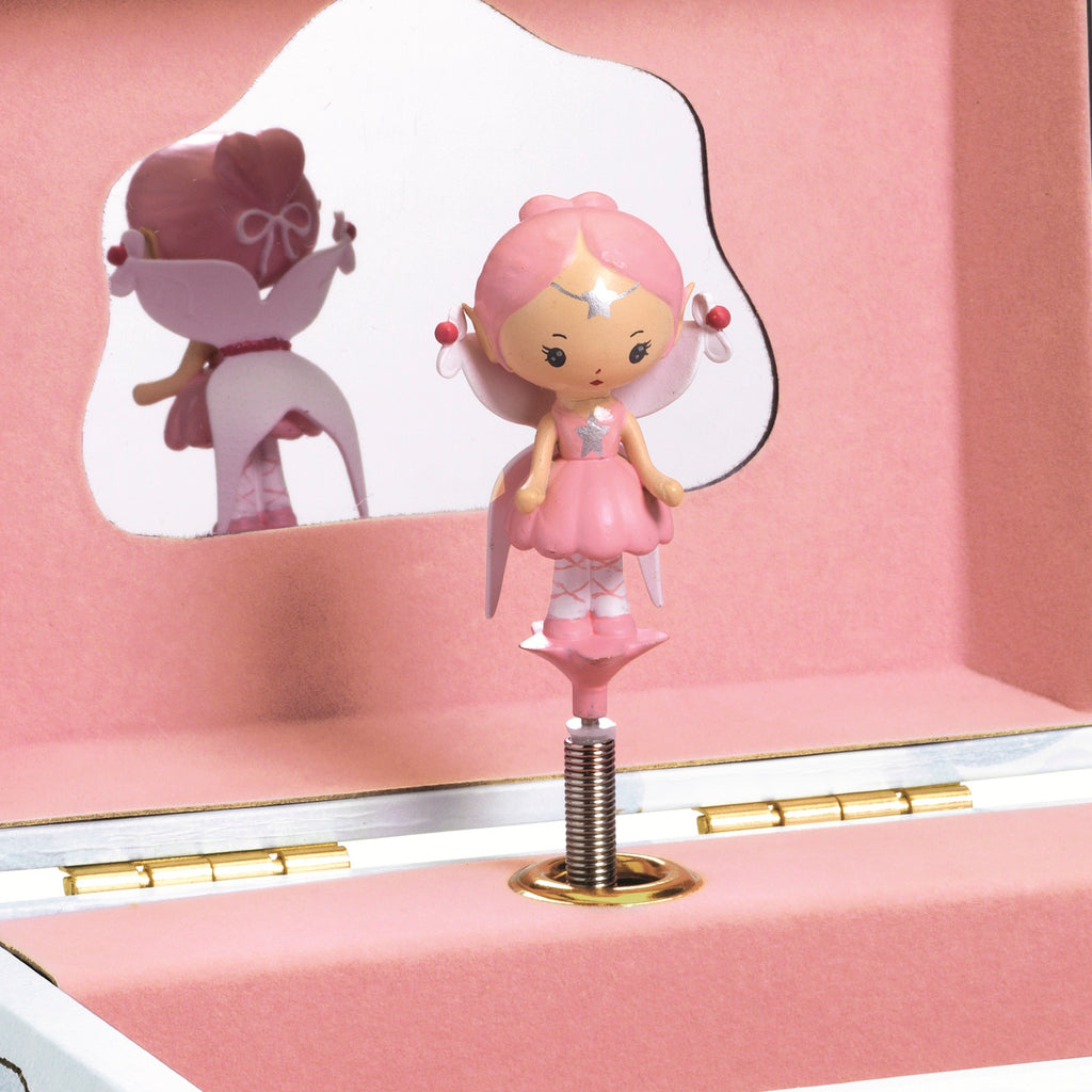 When the crank is turned, the box opens to reveal Elfe, a delicately sculpted figurine, who dances and turns to the music against a backdrop of golden stars.