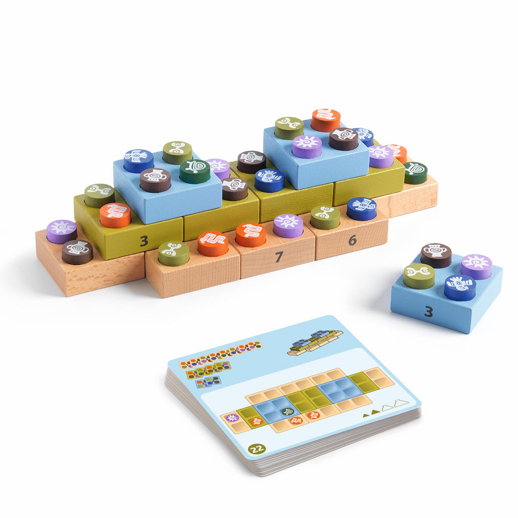 Colorful board game with numbered wooden blocks and round pieces featuring symbols. A card with a grid and illustrations lies nearby. Playful and strategic.