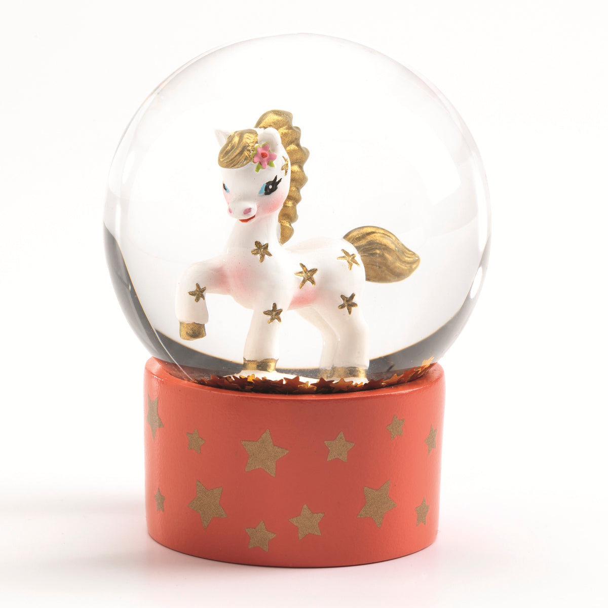 Djeco mini snow globe with a white horse, gold stars, and pink floral detail on an orange base with gold stars.