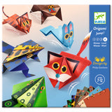 A craft kit featuring colorful paper designs and folded animal shapes like frogs and kangaroos that can hop when pressed.