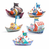 With brightly colored, coated paper boats designed to float on water after folding.
