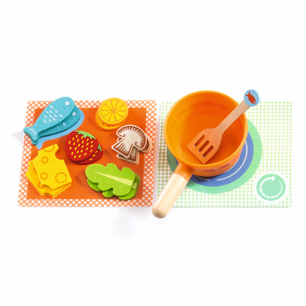 A colorful children's play dining set with two plates, cups, utensils, and toy food, accompanied by two cartoon cats.