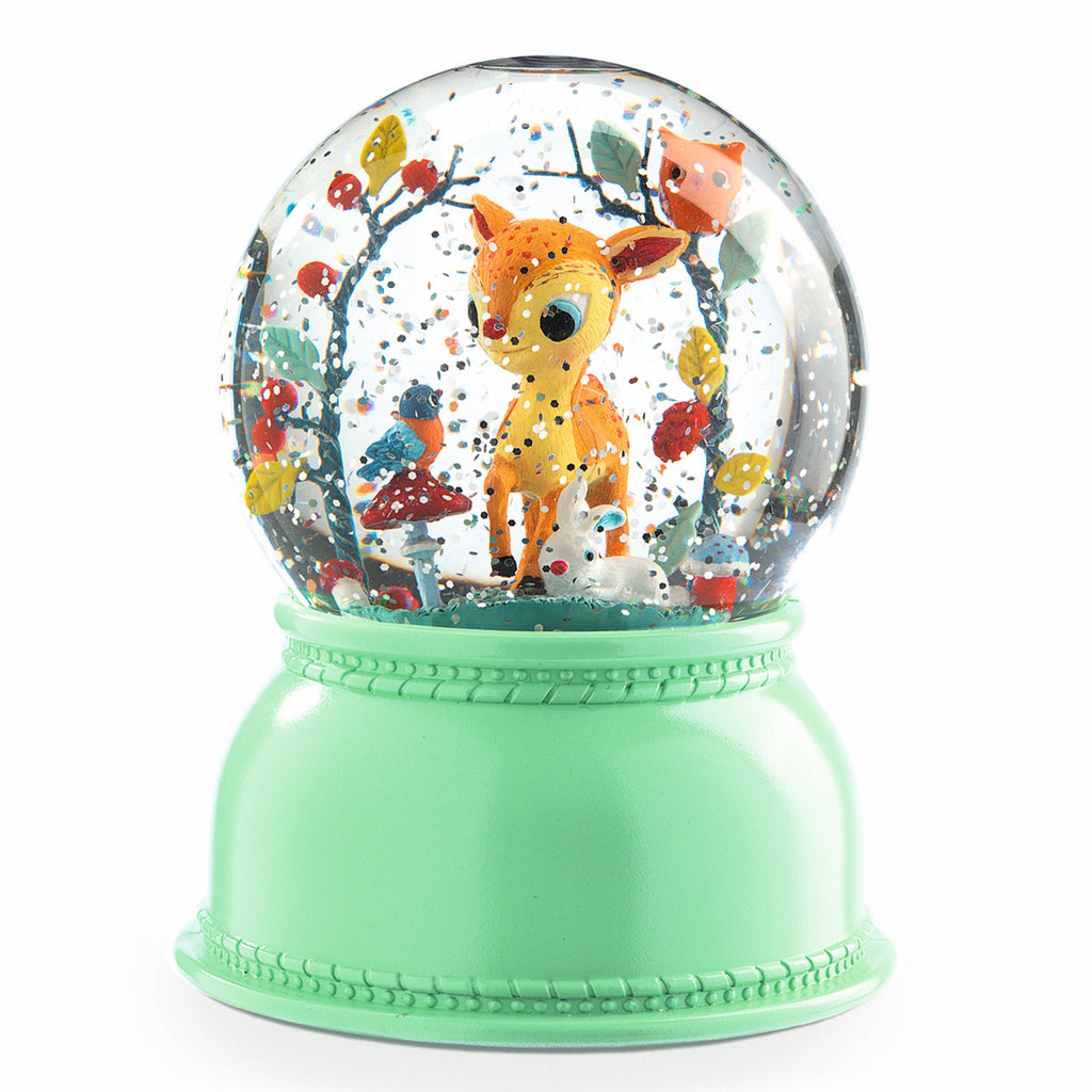 A whimsical snow globe featuring a deer, rabbit, and birds amidst colorful branches. The mint green base adds a playful, cheerful touch.