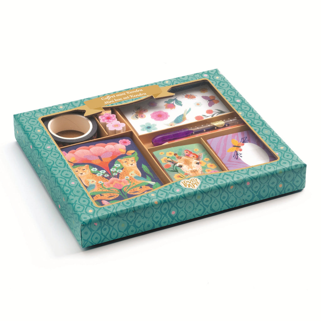 A colorful stationery set in a teal patterned box features floral designs, a giraffe, and cheetahs. Includes a pen, tape, and cards, conveying a playful tone.