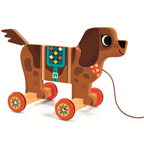 A colorful wooden pull-along toy dog with wheels, a patterned saddle, and a leash, designed for playful imagination.