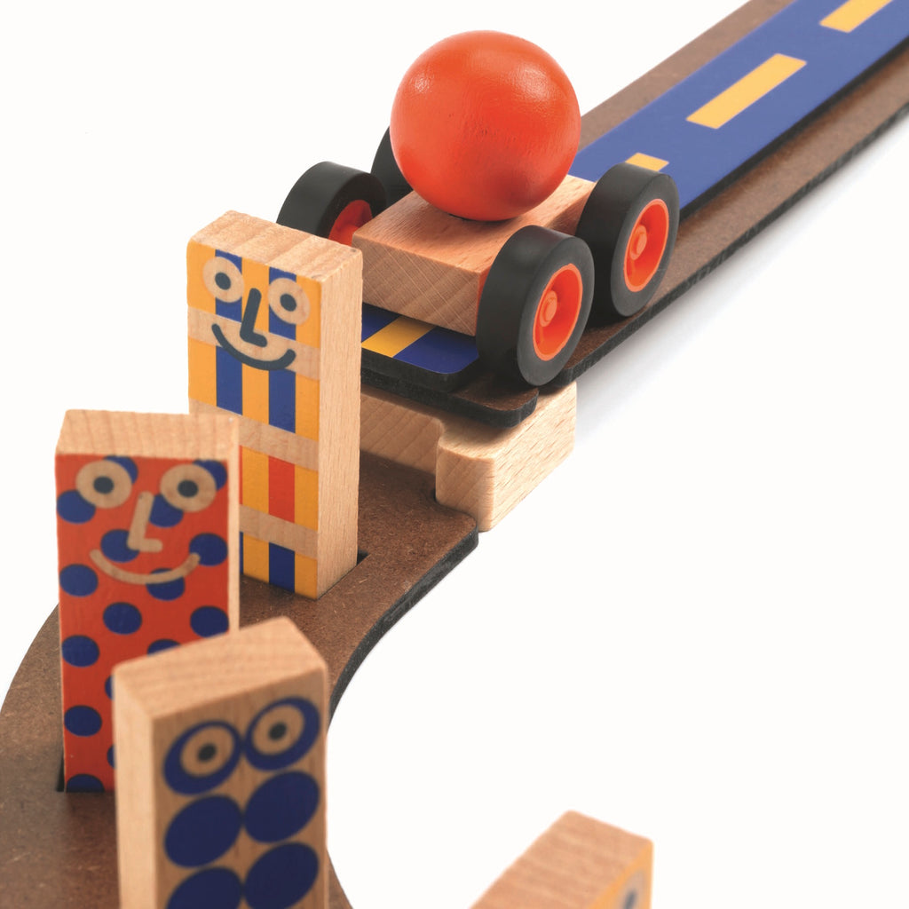 The set comprises 51 pieces, including wooden tracks, ramps, and three large wooden balls.