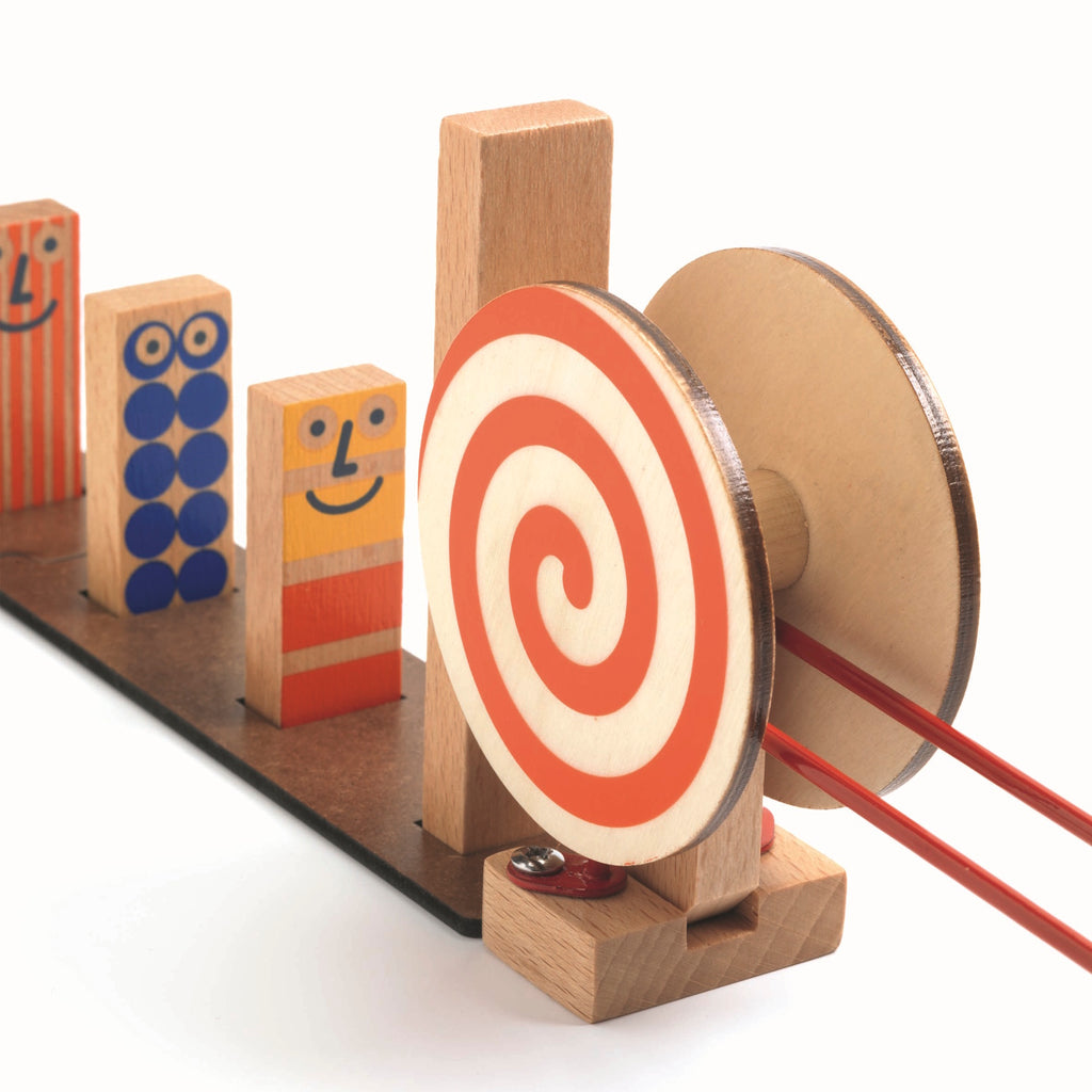 The set comprises 51 pieces, including wooden tracks, ramps, and three large wooden balls.