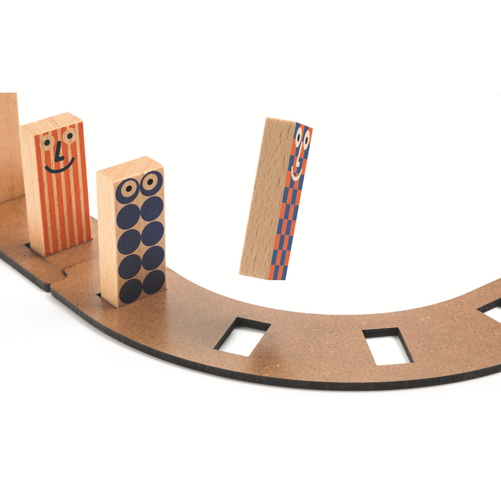 The set comprises 51 pieces, including wooden tracks, ramps, and three large wooden balls.
