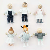 Seven wooden dollhouse family figures arranged in two neat rows against a light pink background.