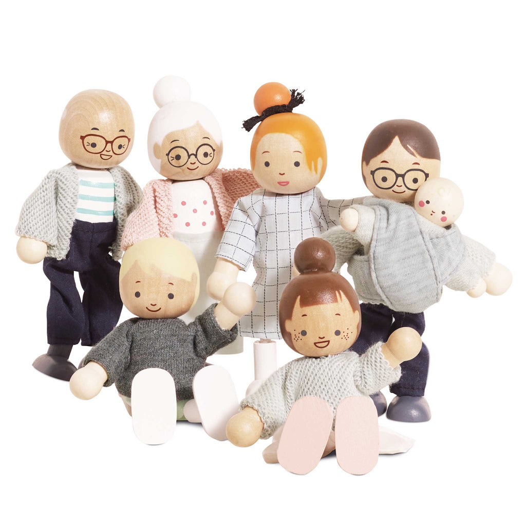 A cheerful wooden doll family with varied skin tones and outfits, including grandparents, parents, and children, all smiling joyfully together.